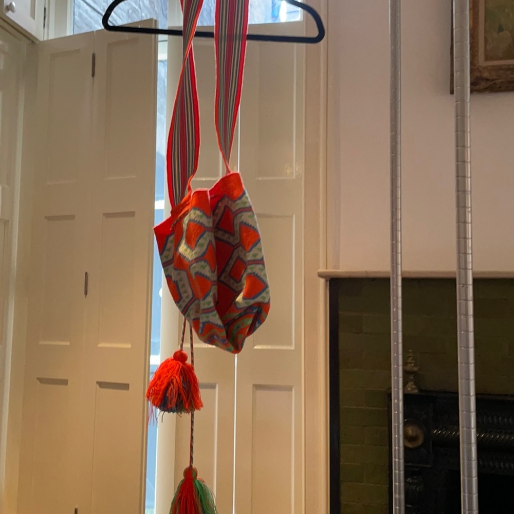 Orange and blue and green bag with tassels.